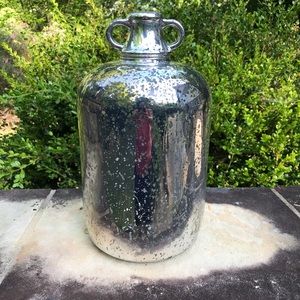 Glass jug with mercury glass finish. 13” tall. 6 1/2” in diameter.